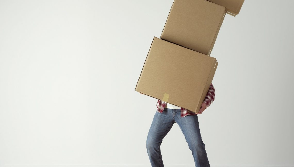 Person holding moving boxes